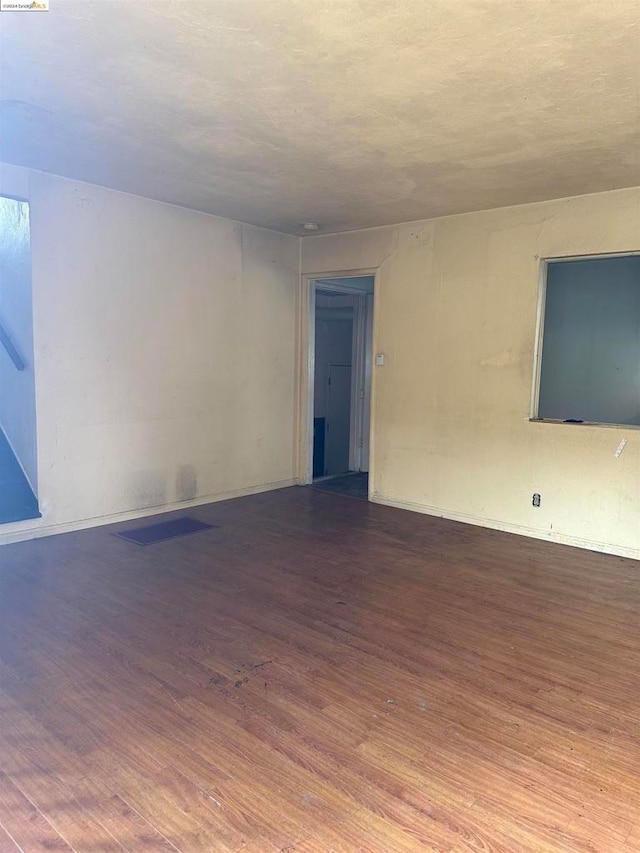 empty room with hardwood / wood-style floors