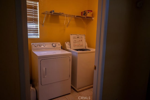 laundry room featuring light tile patterned floors and washer and dryer