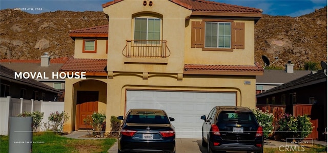 mediterranean / spanish-style house featuring a garage, a tile roof, concrete driveway, and stucco siding