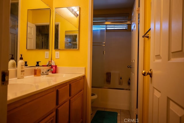 full bathroom with tile patterned floors, shower / bath combination with glass door, vanity, and toilet