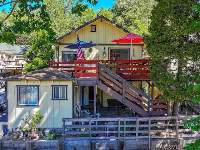 back of house featuring a wooden deck