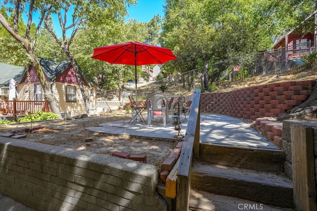 wooden terrace featuring a patio