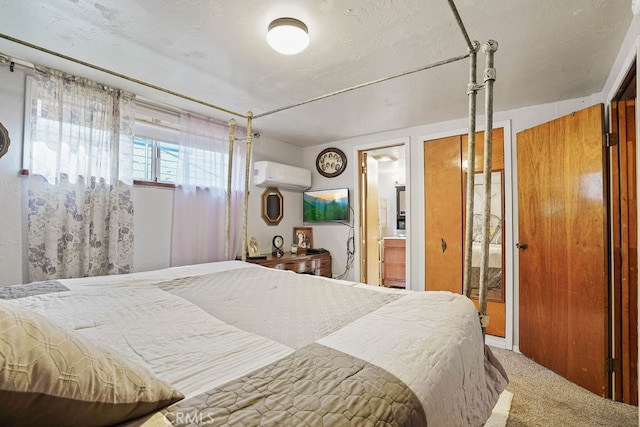 carpeted bedroom with a wall unit AC and connected bathroom