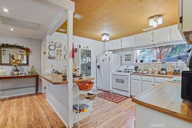 kitchen featuring white cabinets, kitchen peninsula, white appliances, butcher block countertops, and light hardwood / wood-style flooring