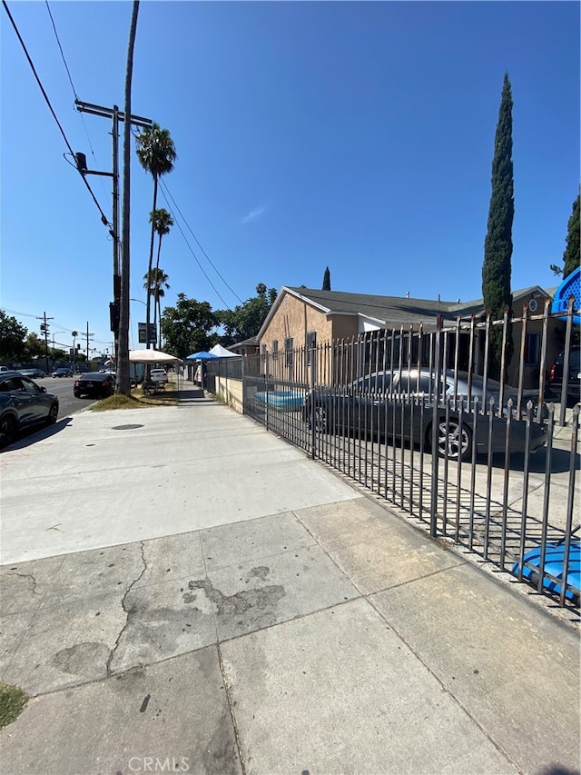 view of gate with a pool