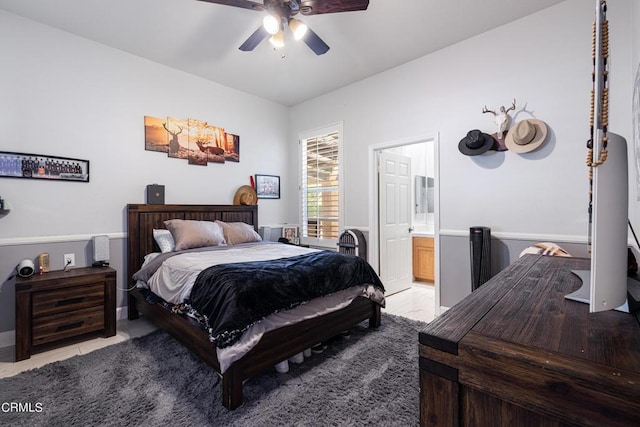 bedroom featuring ensuite bath, ceiling fan, and light tile patterned floors