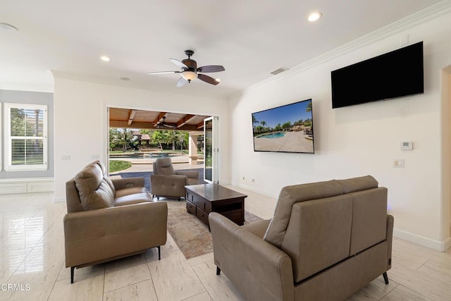 living room with ceiling fan and ornamental molding