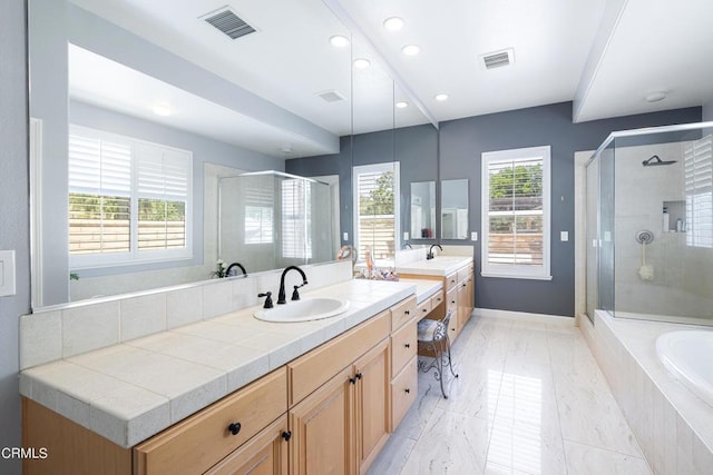 bathroom featuring vanity and separate shower and tub