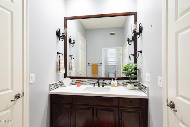 bathroom featuring decorative backsplash and vanity