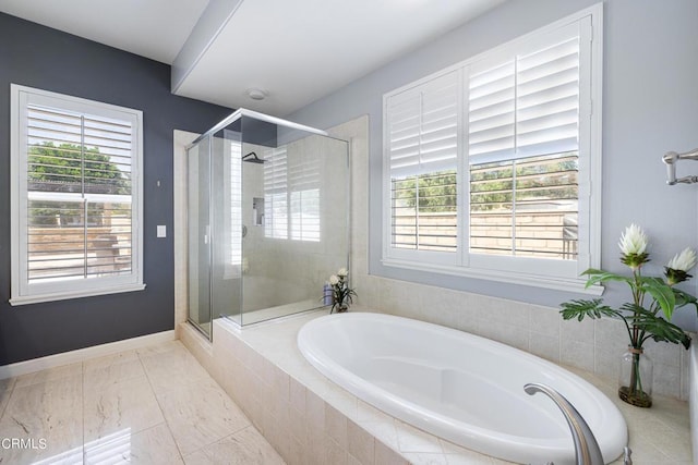 bathroom featuring independent shower and bath