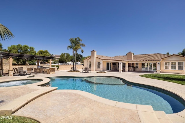 view of pool featuring a patio area and an in ground hot tub