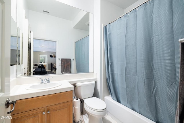 full bathroom with vanity, shower / bath combination with curtain, and toilet