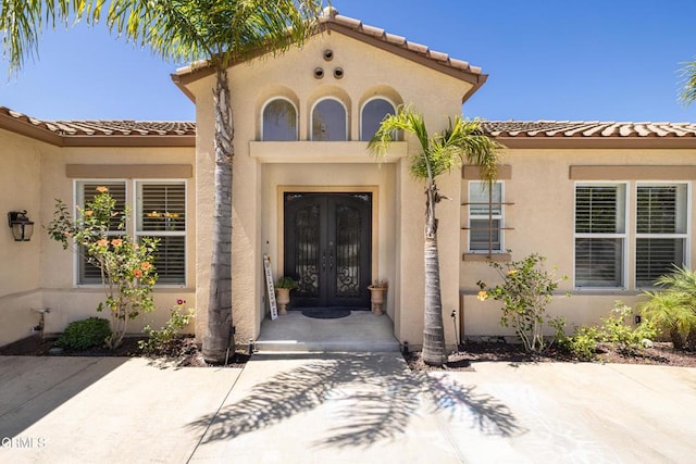 view of exterior entry featuring french doors