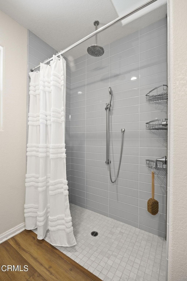 bathroom with a shower with curtain and hardwood / wood-style floors