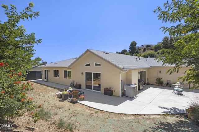 back of house featuring a patio area and central air condition unit