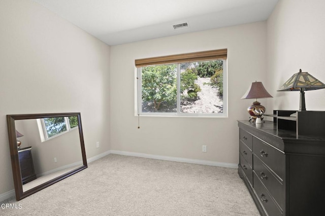 carpeted bedroom featuring multiple windows