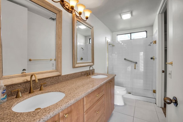 bathroom featuring tile patterned flooring, a shower with shower door, vanity, and toilet