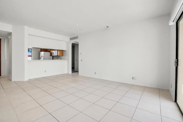 unfurnished living room featuring light tile patterned floors