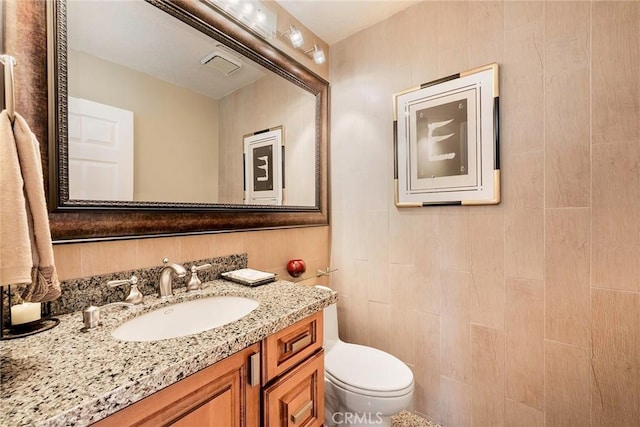 bathroom featuring toilet and vanity