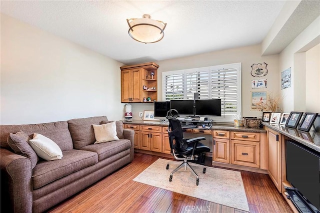 office featuring a textured ceiling and hardwood / wood-style flooring