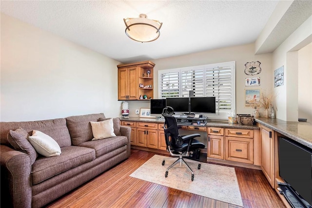 office space with a textured ceiling and hardwood / wood-style flooring