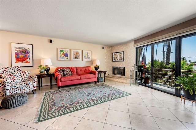 living room featuring a textured ceiling, light tile patterned floors, and a fireplace