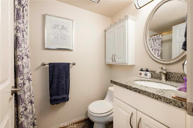 bathroom with toilet and vanity