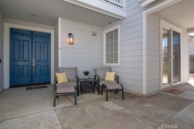 property entrance with a balcony and covered porch