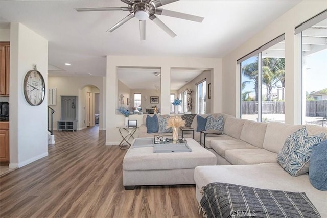 living room with hardwood / wood-style flooring and ceiling fan