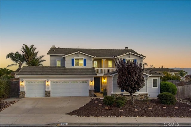 view of front property with a garage and a balcony