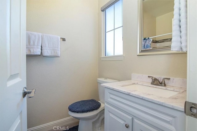 bathroom with vanity, toilet, and curtained shower