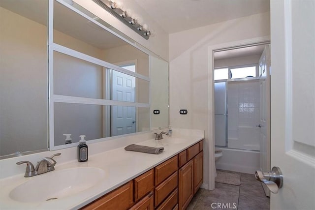 full bathroom featuring combined bath / shower with glass door, vanity, tile patterned floors, and toilet