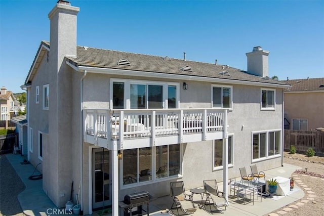 rear view of house with a balcony