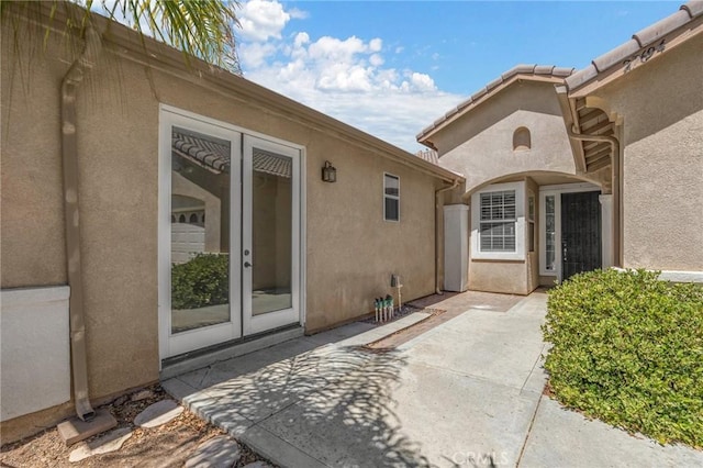 entrance to property with a patio and french doors