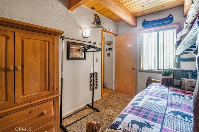 carpeted bedroom featuring beamed ceiling and wooden ceiling