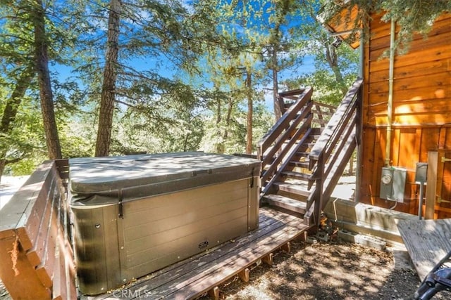 exterior space with a hot tub and a deck