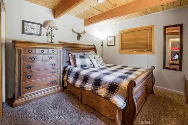 bedroom featuring dark colored carpet, wooden ceiling, and beamed ceiling