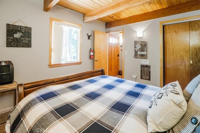 bedroom featuring beamed ceiling and wooden ceiling