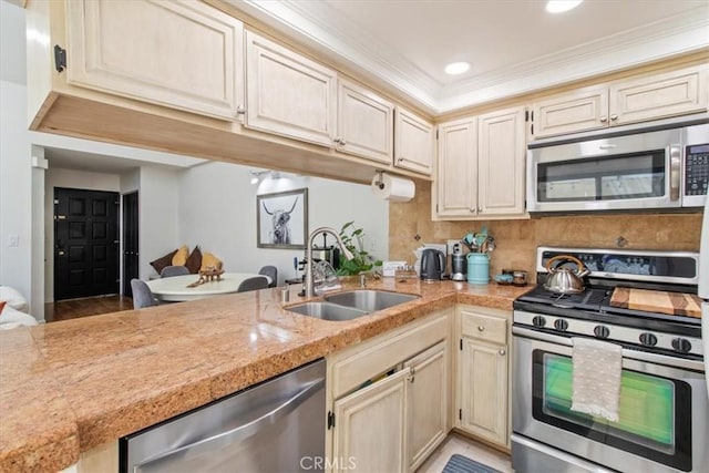 43334 32nd St W Unit 44, Lancaster, CA 93536 - kitchen with stainless steel appliances, a peninsula, ornamental molding, tasteful backsplash, and recessed lighting