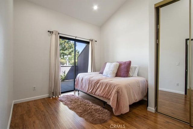 43334 32nd St W Unit 44, Lancaster, CA 93536 - bedroom with wood finished floors, lofted ceiling, and access to exterior