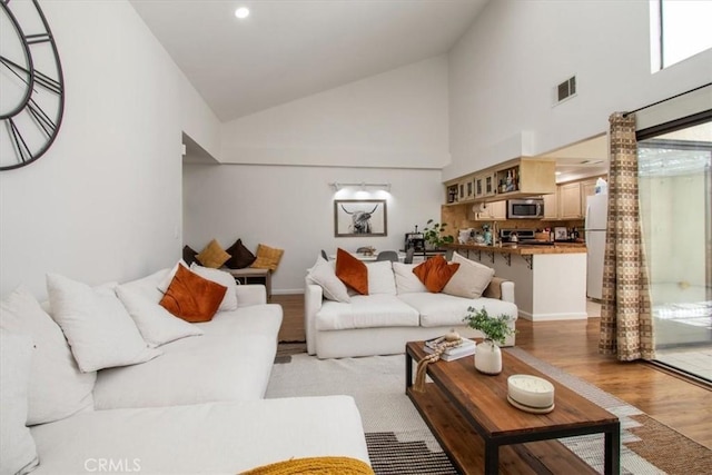 43334 32nd St W Unit 44, Lancaster, CA 93536 - living area featuring light wood-style floors, high vaulted ceiling, and recessed lighting
