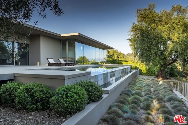 view of side of property featuring a patio area