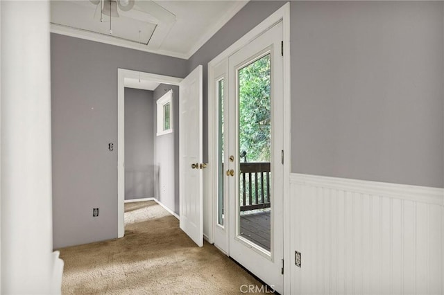 doorway with light colored carpet and ornamental molding