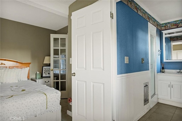 bedroom featuring sink and dark tile patterned floors