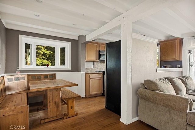 kitchen with tasteful backsplash, beam ceiling, dark hardwood / wood-style floors, and stainless steel appliances