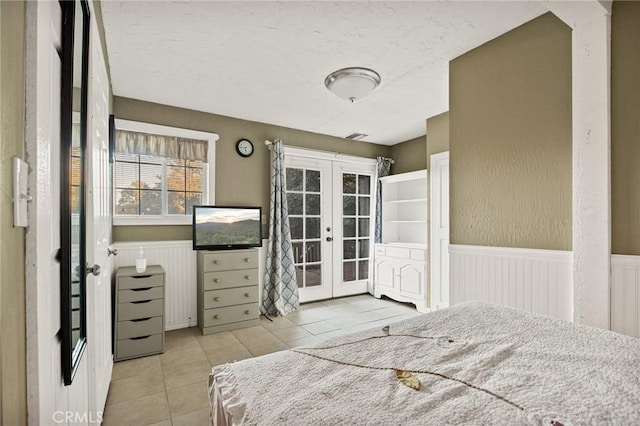 bedroom featuring light tile patterned floors and french doors