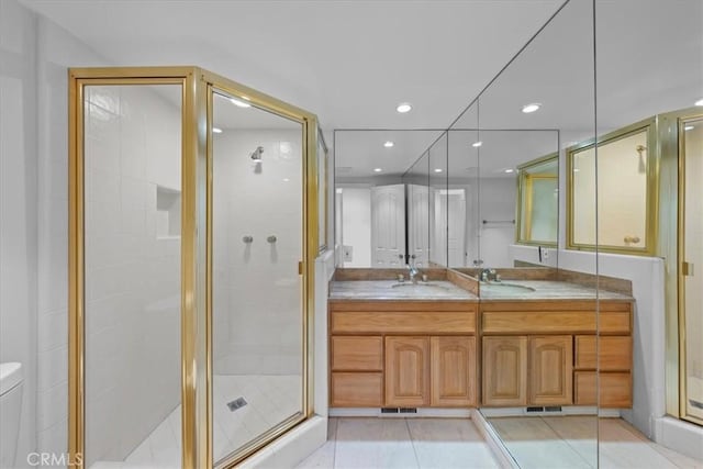 bathroom with a shower with door, toilet, tile patterned flooring, and vanity