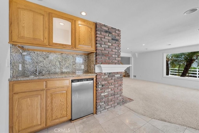 kitchen with light stone countertops, light carpet, sink, backsplash, and stainless steel refrigerator