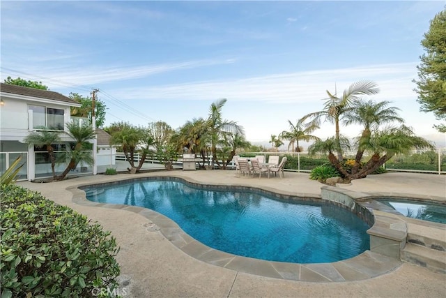 view of swimming pool with an in ground hot tub and a patio area