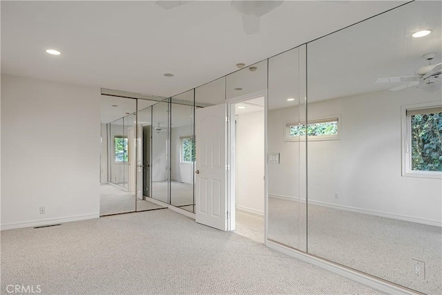 unfurnished bedroom with ceiling fan and carpet flooring